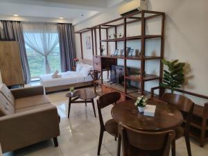 a living room with a couch and a table at Timurbay Seafront By Moonlight in Kuantan +62 photos