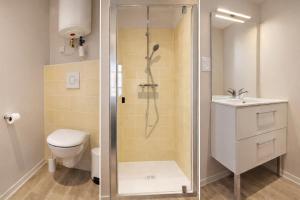 a bathroom with a shower and a toilet and a sink at Hôtel des Thermes in Bourbon-Lancy +26 photos