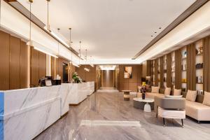 a lobby of a hotel with couches and tables at FeNo AESTHETIC DESIGNER Hotel Beijing Road Pedestrian Street Branch in Guangzhou