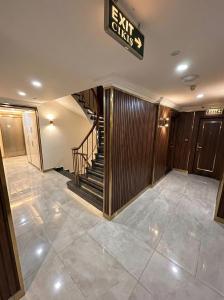 a lobby with a staircase and a sign that reads exit sets at B Corner Hotel Bistro in Istanbul