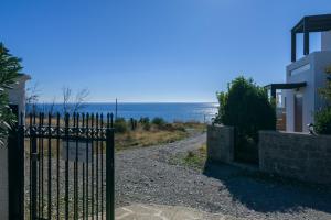 a gate to a house with a view of the ocean at Villa Nastazia in Kiotari