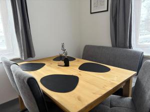 a wooden table with four chairs around it at Ferienwohnung Eichhorner in Außervillgraten +20 photos