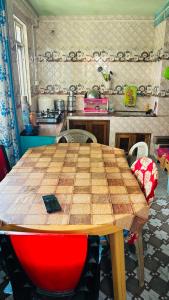 a kitchen with a wooden table with chairs and a table at NV Anjali Homestay in Sukhia Pokhari +52 photos