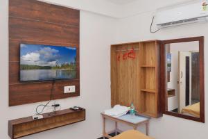 a room with a table and a tv on a wall at HOTEL LS Residency in Salem +11 photos
