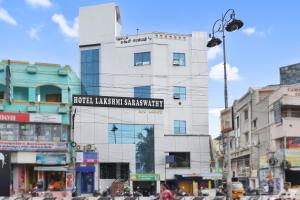 a tall white building with a sign on it at HOTEL LS Residency in Salem