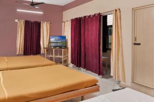 a hotel room with two beds and a television at HOTEL LS Residency in Salem