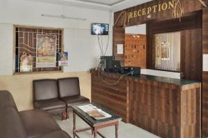 a waiting room with a counter and a chair at HOTEL LS Residency in Salem