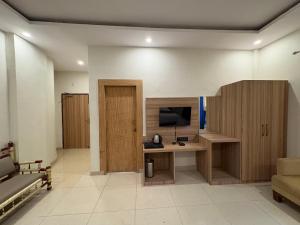 a room with a desk and a tv and a couch at MJ Funcity Water Park & Resort in Lucknow