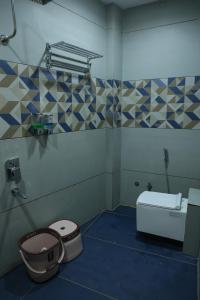 a bathroom with a toilet and a sink at Hotel Shiv Om in Ujjain +31 photos