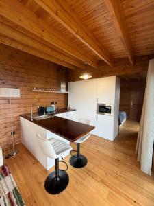 a kitchen with a table and chairs in a room at Sunset Eco Shelter 1 in Ponta do Pargo