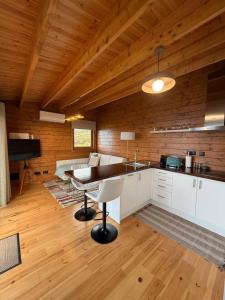 a kitchen with a table and a piano in a room at Sunset Eco Shelter 1 in Ponta do Pargo