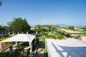 an overhead view of a tennis court with tables and umbrellas at Belvedere in Procida