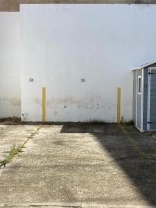 an empty parking lot with a white wall and a door at Livingtarifa Jazmín in Tarifa