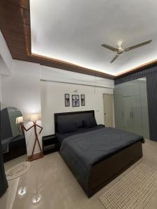a bedroom with a bed and a ceiling fan at Shiva Stays - Make yourself at home in Lucknow