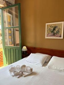 a bedroom with a bed with two pairs of shoes on it at Grande Hotel Torres in Torres