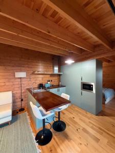 a kitchen with a table and chairs in a room at Sunset Eco Shelter 5 in Ponta do Pargo