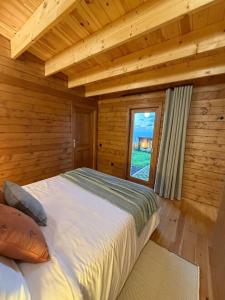 a bedroom with a bed in a wooden cabin at Sunset Eco Shelter 5 in Ponta do Pargo +14 photos