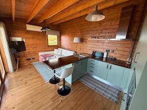 a kitchen with a table and a bed in a room at Sunset Eco Shelter 2 in Ponta do Pargo