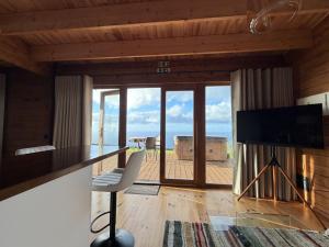 a living room with a view of the ocean at Sunset Eco Shelter 3 in Ponta do Pargo