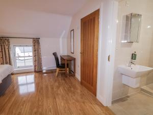 a bedroom with a sink and a bathroom with a desk at Foyle Cottage in Strabane +28 photos