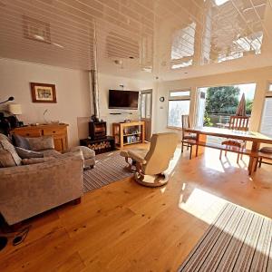 a living room with a couch and a table at Dinky Daze Norfolk Broads in Brundall