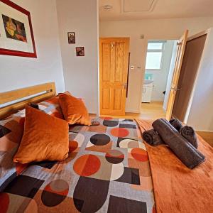 a bedroom with a large bed with pillows on it at Dinky Daze Norfolk Broads in Brundall