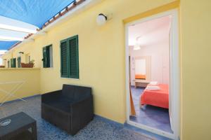 a room with a room with a bed and a window at Belvedere in Procida