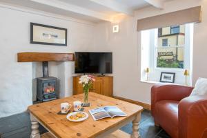 a living room with a table and a fireplace at Ty Draw in HAW