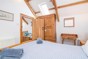 a bedroom with a bed in a room with wooden ceilings at Ty Draw in HAW