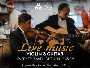 two men playing violins and aviolin at Amanaki Thao Dien in Ho Chi Minh City
