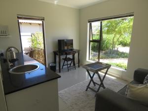 a living room with a large window and a sink at the range in Langebaan