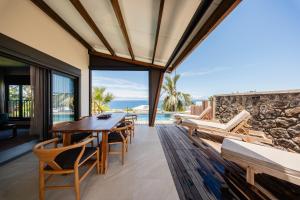 a dining room with a view of the ocean at Villa de Luxe avec Piscine privée chauffée-3 Chambres-Sud Sauvage in Petite Île