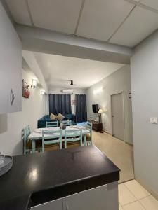 a kitchen and living room with a table and a couch at Elegant 1BHK at Shiva Stays, behind lulu mall in Lucknow +13 photos