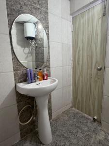 a bathroom with a sink and a mirror at Elegant 1BHK at Shiva Stays, behind lulu mall in Lucknow