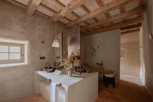 a bathroom with a counter and a sink in a room at Hotel Vestige Binidufà in Isla de Menorca