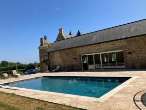 a swimming pool in front of a house at Château du Hardas in Segré