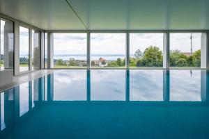 an empty swimming pool with a view of the water at Hotel Heiden - Wellness am Bodensee in Heiden
