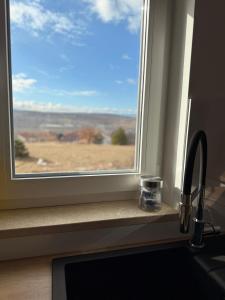 a window with a view of a field at Apartman Sara in Posušje +17 photos