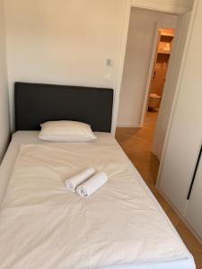 a bed with two towels on top of it at Apartman Sara in Posušje