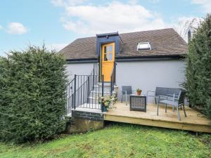 a house with a deck with a yellow door at Golden Valley View in Stroud