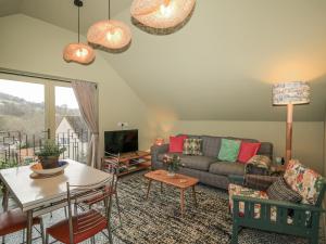 a living room with a couch and a table at Golden Valley View in Stroud