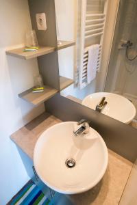 a bathroom with two sinks and a mirror at Chateau De La Plinguetiere in Saint-Aignan-Grand-Lieu