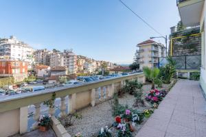 a balcony of a building with flowers on it at Seashell Luxury Rooms Sanremo in Sanremo