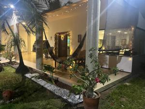 a house with a hammock in the front yard at Casa de praia in São Luís