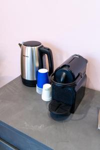 a coffee maker sitting on top of a counter at Seashell Luxury Rooms Sanremo in Sanremo +42 photos