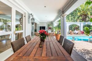 a dining room with a wooden table and chairs at Maison du Cap in Cape Town +48 photos
