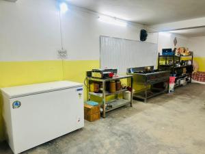 a kitchen with a white refrigerator in a room at Willow Winds Home Stay in Theog