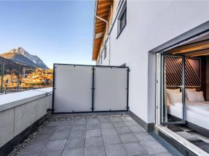 a balcony with a bed and a view of a mountain at B&B HOTEL Mittenwald in Mittenwald
