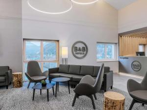 a living room with a couch and chairs at B&B HOTEL Mittenwald in Mittenwald