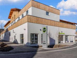 a white building with a brick wall at B&B HOTEL Mittenwald in Mittenwald +19 photos